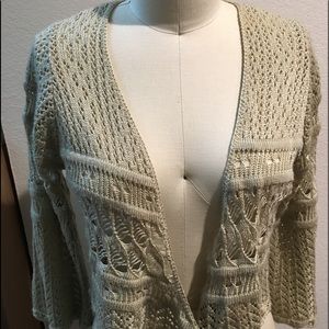 Knit sweater top with tie fronts and bell sleeves.